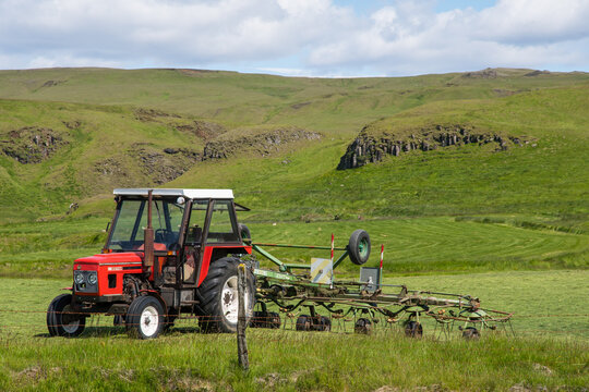 Zetor tractor with carousel tedder on a field
