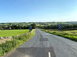 View along, Mill Hurst., with trees and hills, in the distance in, Dacre, Harrogate, UK
