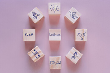 Business development strategy and Action plan concept, wooden blocks with business process management icons on a pink background, copy space