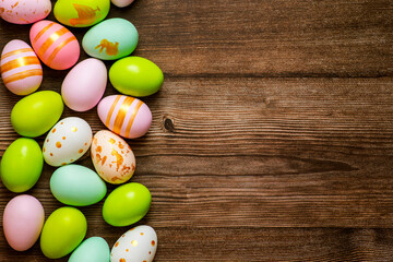 Fototapeta na wymiar Easter eggs on wooden background. Colorful Easter eggs on a wooden background of boards