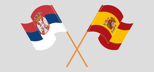 Crossed and waving flags of Serbia and Spain