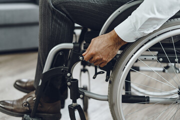 Obraz premium Unrecognizable man sitting in wheelchair close up