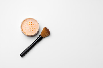 Decorative cosmetics face powder and brush close up