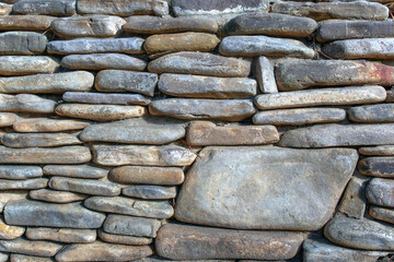 Fragment of a wall from stones different size.