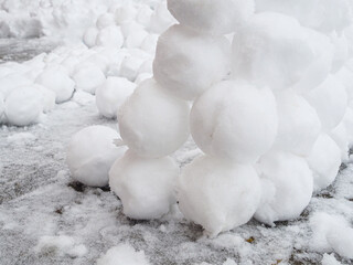 There are many round snowballs in the snow. Winter fun. Abstract new year christmas background. Copy space.