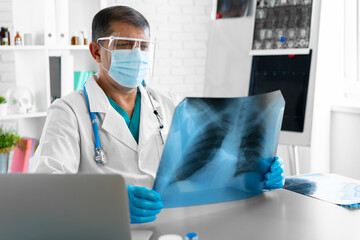 Doctor examining lungs x-ray scan in his office in hospital