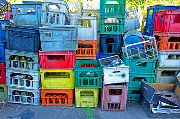 Stacks plastic bottle baskets piled up behind tiny grocery and pub. Konewka Central Poland © Steve