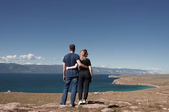 Man and woman on the shore of Lake Baikal in summer