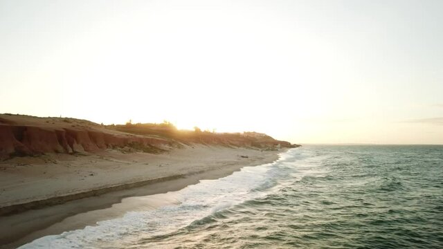 Aerial view in over exposed light by sunset of sand cliff in Canoa Quebrada Beach, Cear&aacute;, Brazil.