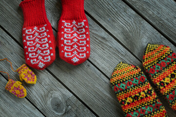 Knitted mittens on a wooden table. Winter family walk concept. Copy space for text