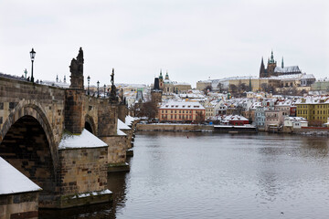 Snowy Prague Lesser Town with Prague Castle and Charles Bridge above River Vltava, Czech republic