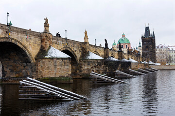 Fototapeta premium Snowy Prague Old Town with Charles Bridge above River Vltava, Czech republic