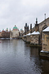 Fototapeta na wymiar Snowy Prague Old Town with Charles Bridge above River Vltava, Czech republic