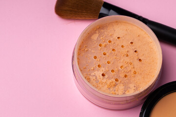 Decorative cosmetics face powder and brush close up