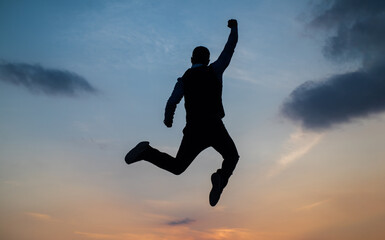 Fototapeta na wymiar man jump high silhouette full of energy against sunset sky, energy