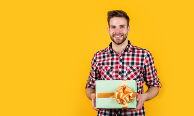 stylish guy with trendy hairstyle wear shirt hold gift box, party