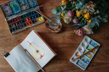 Artist's desktop with watercolors, palette, sketchbook. Still life. Flatley