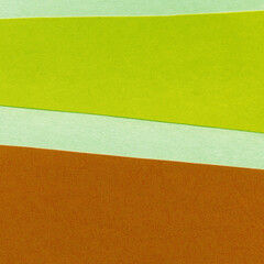 Fototapeta premium Green torn paper collage close-up. Texture made from various paper and cardboard parts. Damaged old paper background. Vintage blank wallpaper. Material design backdrop.