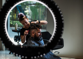 Fototapeta na wymiar barber master cut hair. mature hipster with beard at hairdresser. hipster with moustache making new hairstyle. barbershop. male trendy hairdo. perfect haircut with blade razor. Professional choice