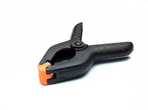 Black Muslin Clamp With Orange Pads For Use In Photo Studio