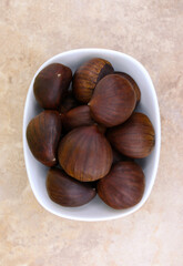 Top view of chestnuts in a white bowl