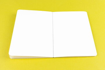 Open copybook mock up on yellow background with white pages editable