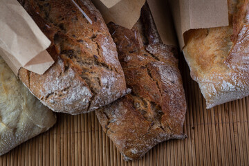 buckwheat and wheat baguettes on the table in paper packages