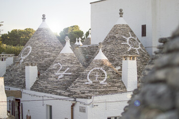 Close up of a conical roofs of a Trulli houses with painted symbols in the southern Italian town of...