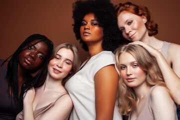 Obraz premium young pretty caucasian, afro, scandinavian woman posing cheerful together on brown background, lifestyle diverse nationality people concept