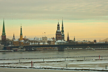 riga. panorama of the city in winter, with a frozen river in the foreground