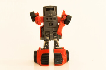Small and old articulated toy robot red and black convertible into auto, used in the 80s.