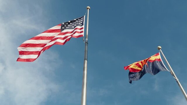 Sunny view of the America and Arizona state flag swinging