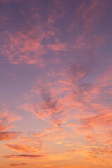 Dramatic soft sunrise, sunset, pink violet orange sky with bright clouds in sunlight background texture