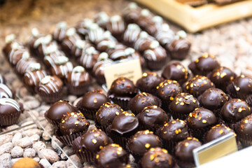 Small cakes in large quantities. Chocolate candies with nut crumbs.