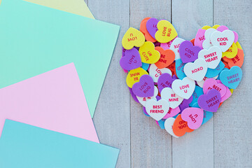 Papel y corazones de colores con palabras relacionadas al amor y la amistad. 