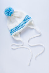 Handmade knitted cap for a child. Blue and white colors. Clothes for little baby. Waiting for baby-boy
