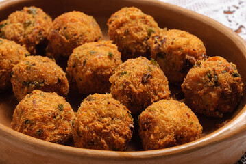 Codfish dumplings served in a clay bowl. Traditional Brazilian cuisine.