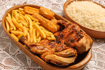 Roasted chicken with breaded bananas and chips. Traditional dish of Brazilian cuisine.