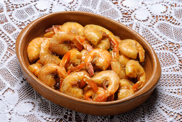 Shrimp with garlic and olive oil, served in a small clay bowl. A traditional snack of Brazilian cuisine.
