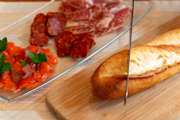 Materials for making canapes,　baguette, salmon and salami on table