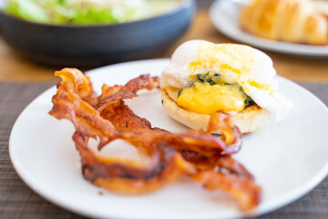 egg benedict with crispy bacon for breakfast