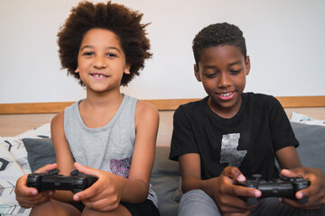 Two brothers playing video games at home.