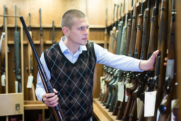 Seller demonstrates a combat winchester in the gun store