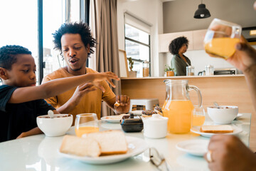 Family having breakfast together at home.