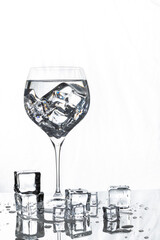 Wine Glass with Ice and Ice Melting on White Background