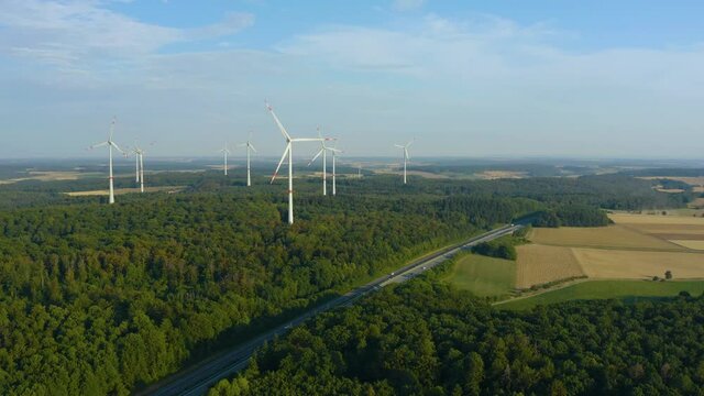 Wind Turbines in Germany on a sunny day in summer in Bavaria beside an Autobahn.