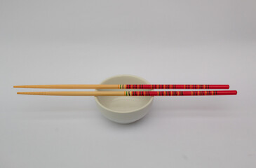 Chopsticks and a white bowl.