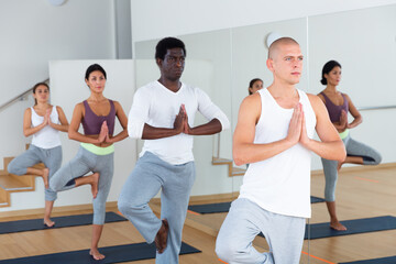 Fototapeta na wymiar People studying new position at yoga modern school