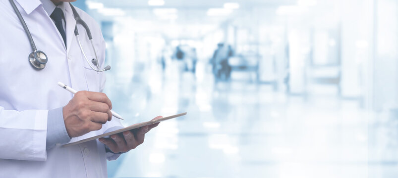 Healthcare and medical concept. Medicine doctor with stehoscope using digital tablet and hospital background