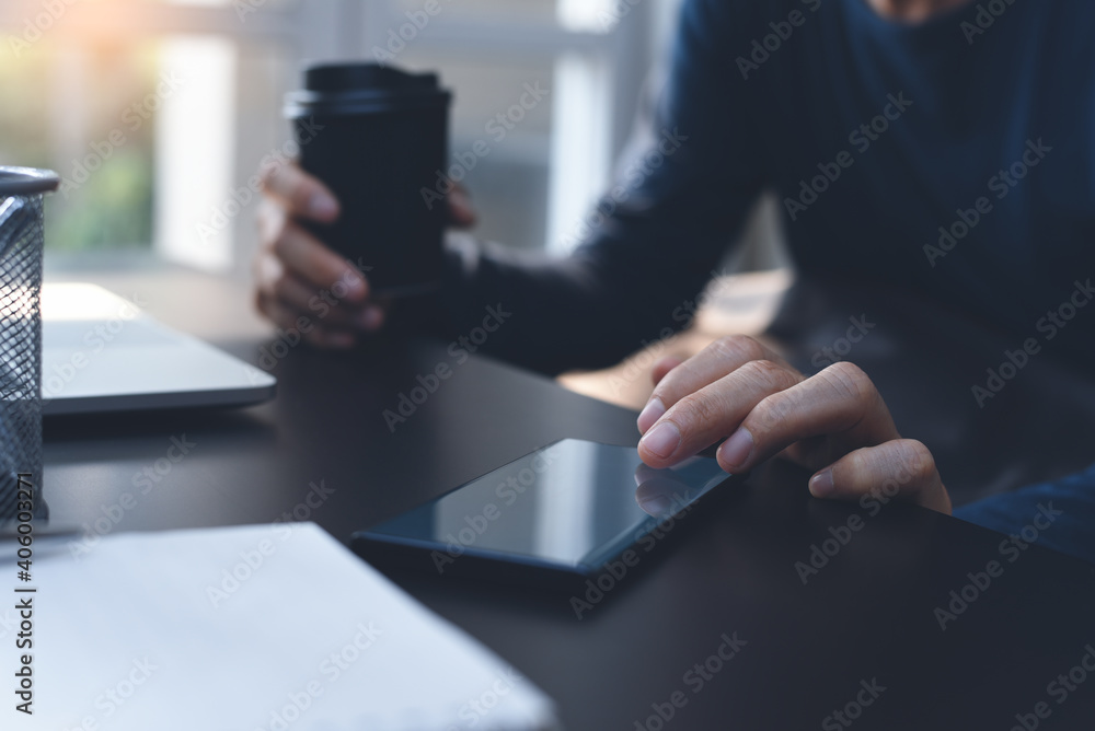 Poster man using using mobile phone and drinking coffee during online working from home office